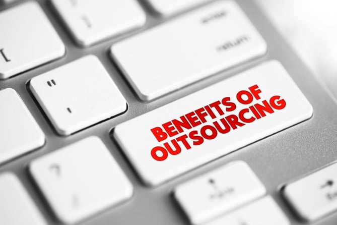 A computer key that says benefits of outsourcing