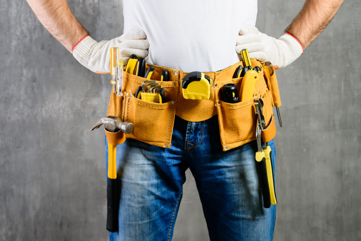 A handyman wearing a tool belt, property maintenance concept