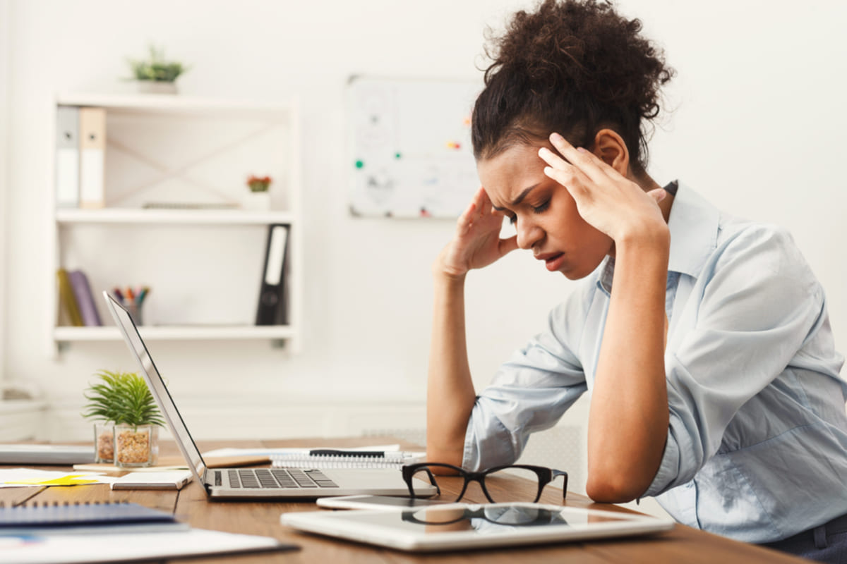 A stressed woman sitting in front of her computer