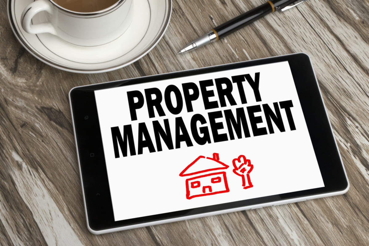 A tablet with the words property management on it, property management companies concept