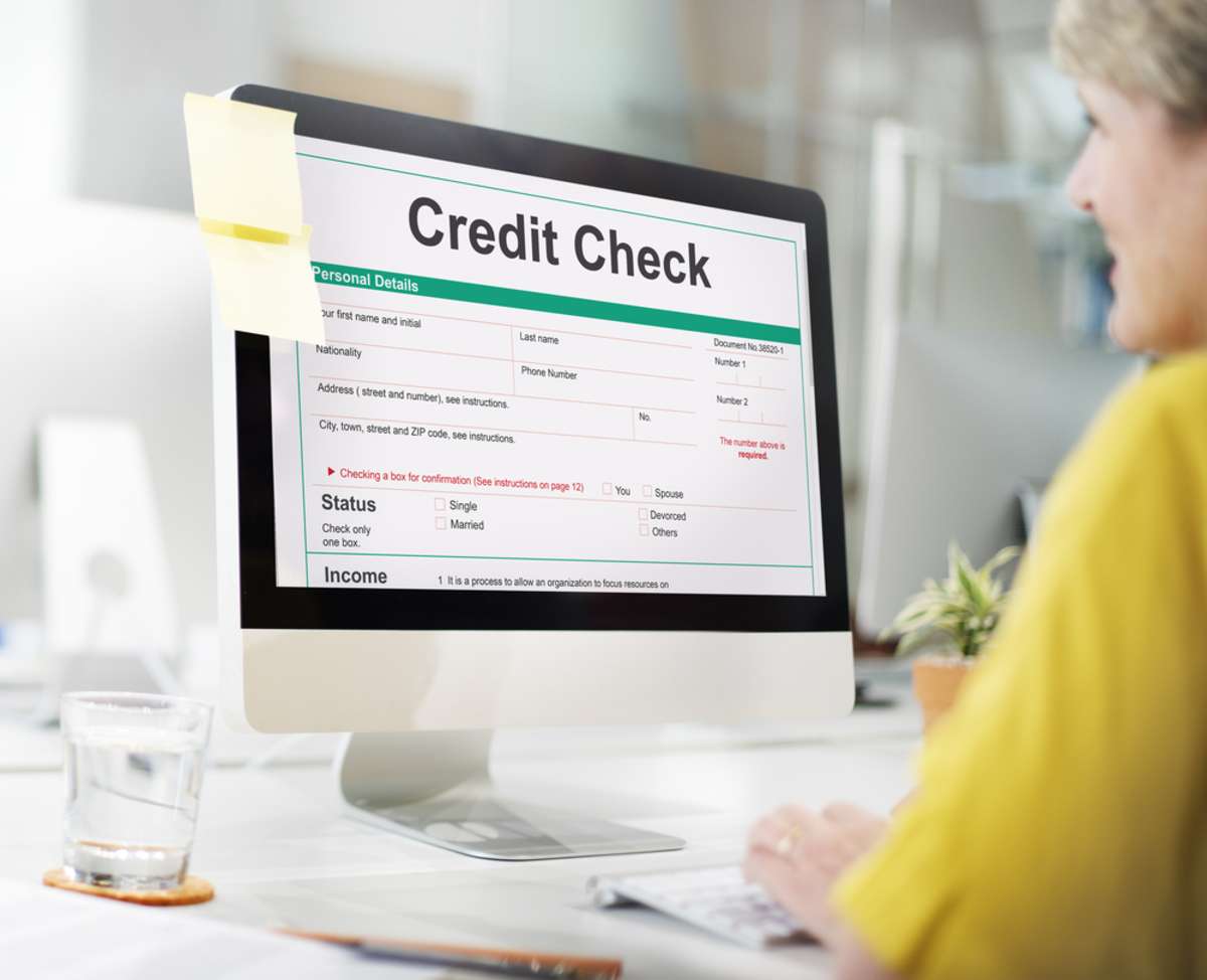 A woman conducts a credit check as part of professional rental property management services-1