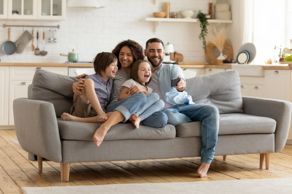 Happy tenants sitting on a couch, Indianapolis property management concept