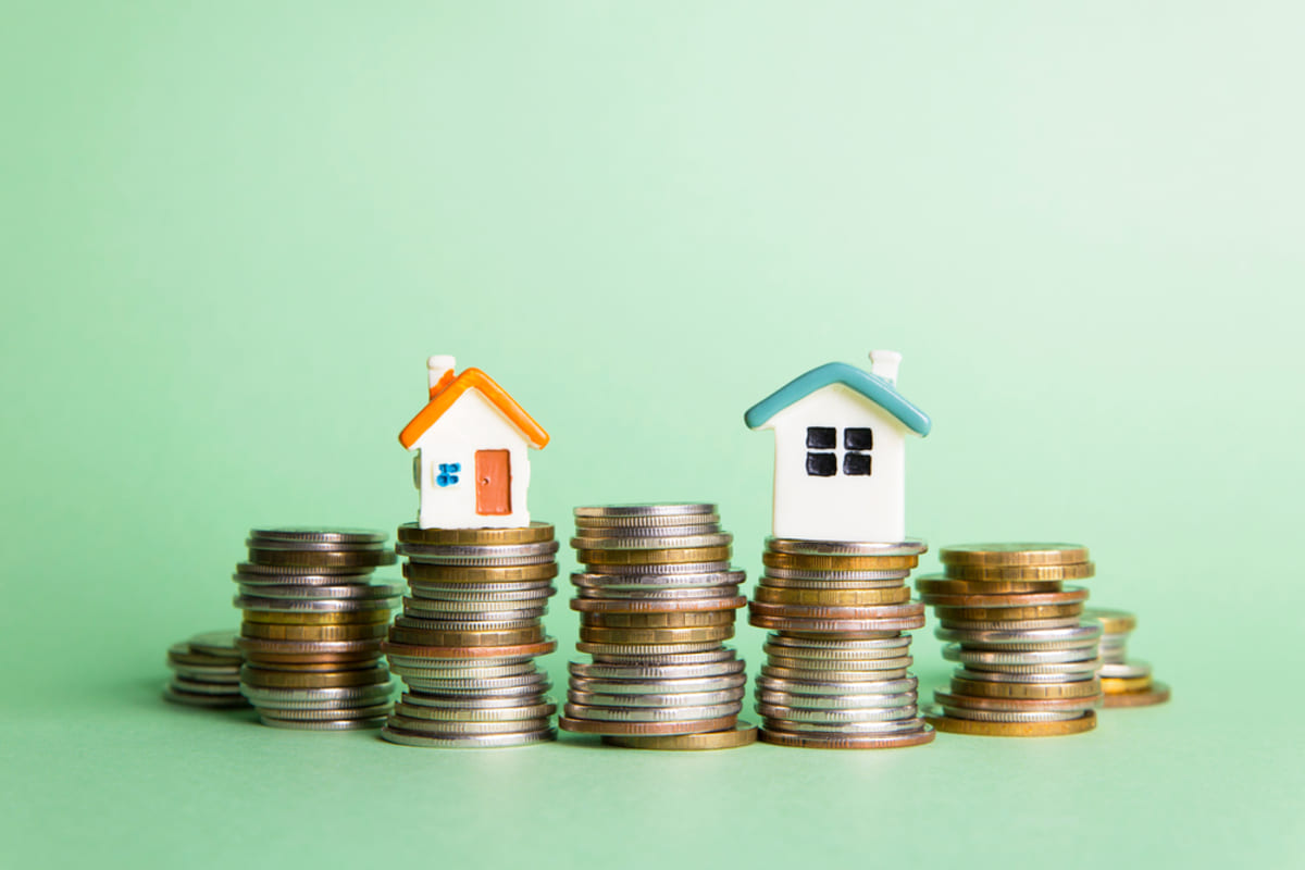Houses on top of coins, maximizing returns with property management concept