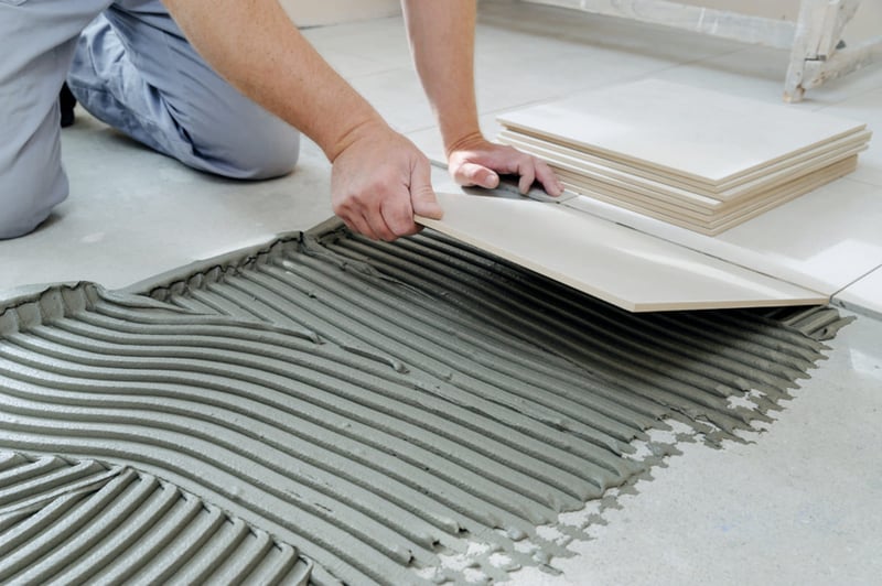 Installing tile flooring, rental property upgrades concept