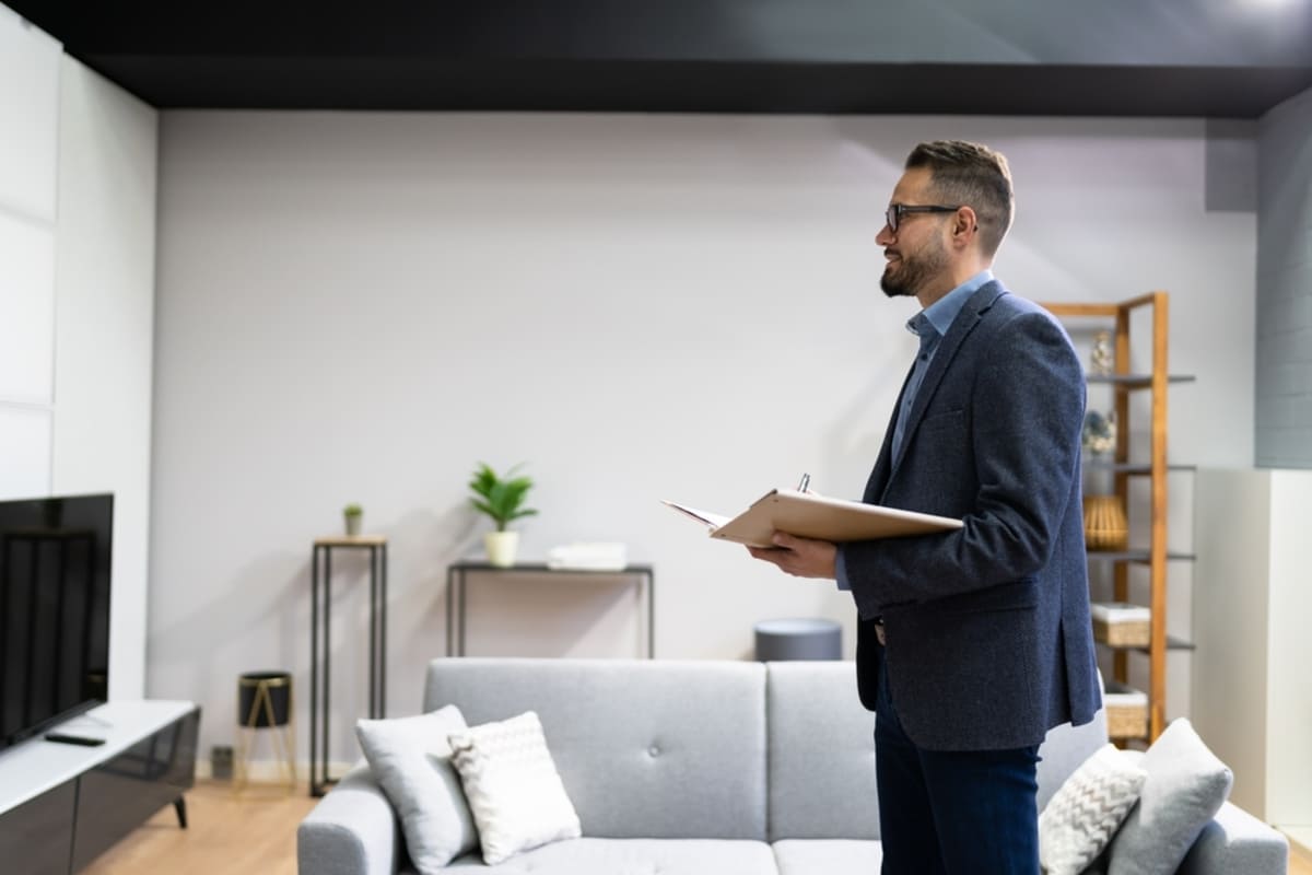 A man conducting a property inspection in a tenant's home, property inspections concept.