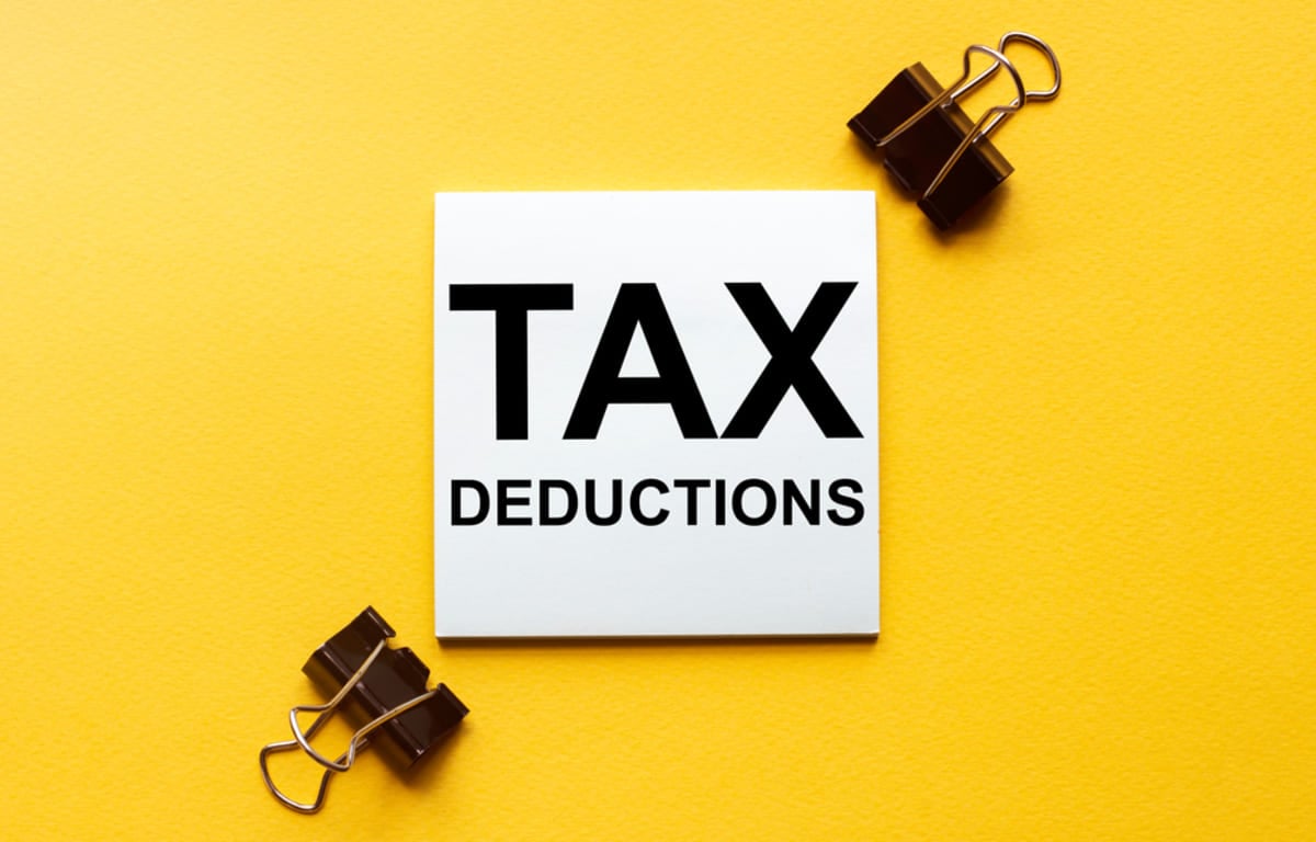 A piece of paper that says tax deductions on a yellow background