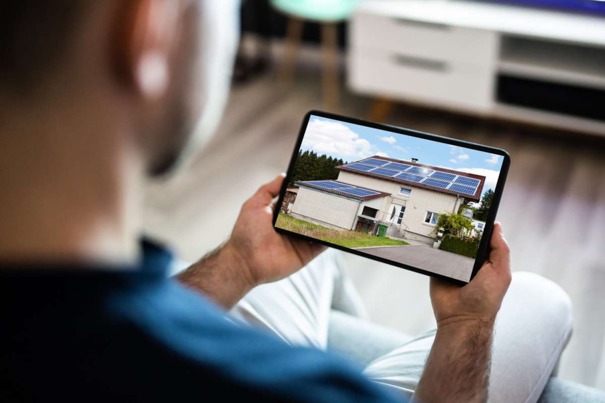 Man looking at a real estate listing on a tablet, how to list rental property concept