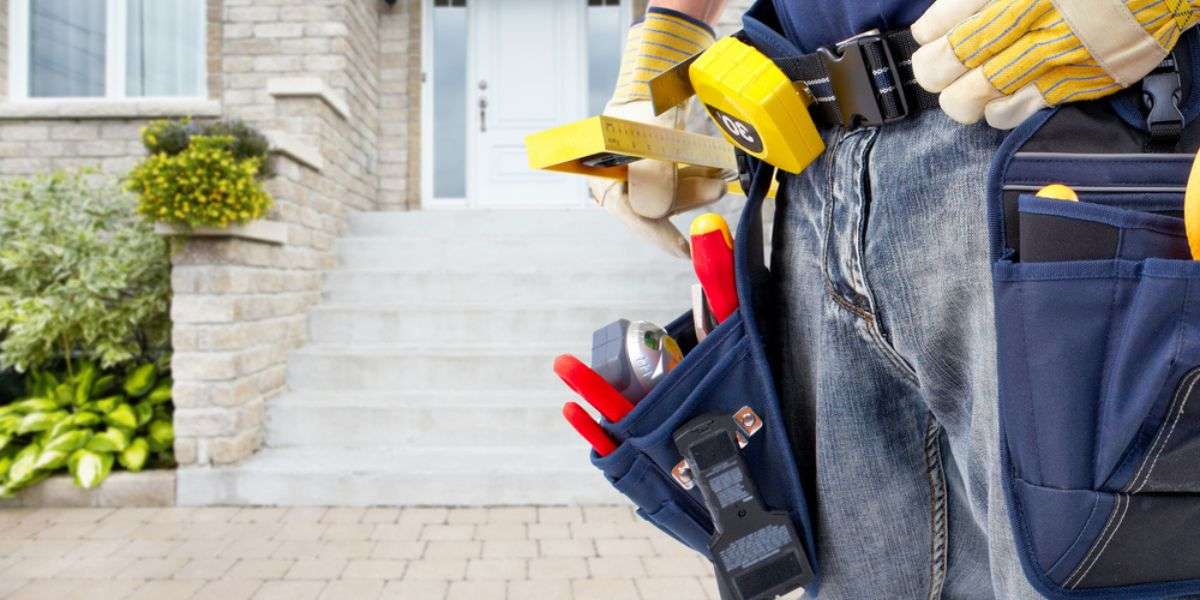 Hands of Handyman with a tool belt