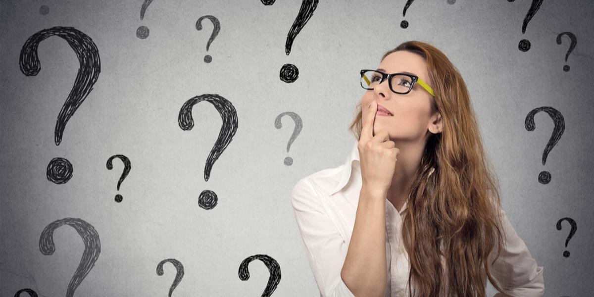 A woman thinking with question marks around her head, questions to ask a property management company concept