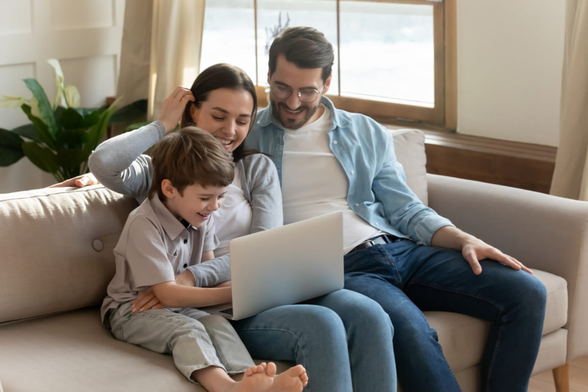 Happy tenants sitting on the couch in their home